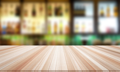 Design concept - Empty wood table top with blur bar background for display or montage product