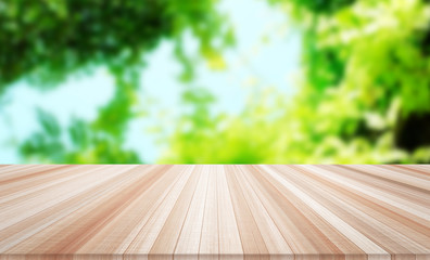 Design concept - Empty wood table top with green leaf background for display or montage product
