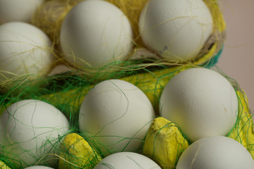 Chicken eggs in colored paper eco-friendly packaging with decorative sisal. Close-up photo, macro. Easter background Food concept 