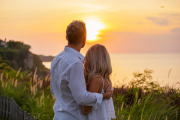 Romantic couple looking at sunset