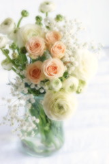 Blur effect, soft focus flowers background with bouquet of pale pink  roses and white ranunculus in a vase .Beautiful Holiday background.copy space.