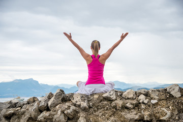 Woman meditating at the lake