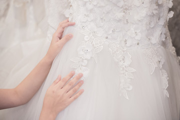  bride is choosing  wedding dress.