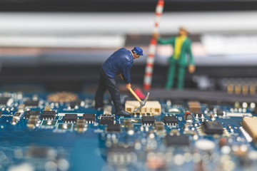 Miniature people : Worker team of engineers repairing keyboard computer laptop