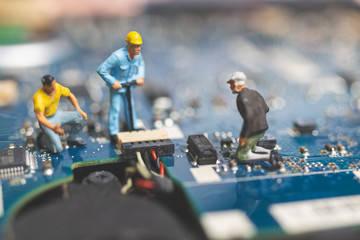 Miniature people : Worker team of engineers repairing keyboard computer laptop