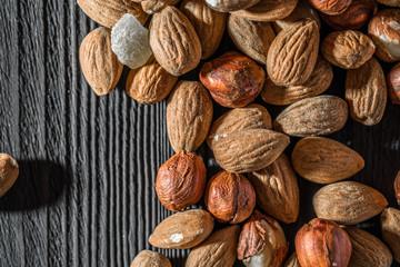 almonds on wood textured background, top view, close-up