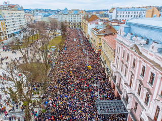 LVIV, UKRAINE - APRIL 6, 2018: Procession with a large cross. The crowd is walking their temple to...