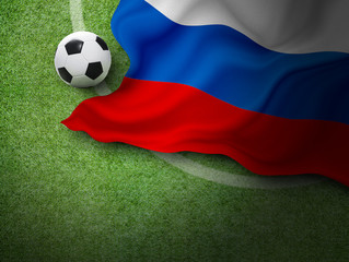 Soccer ball and russia flag on green grass in stadium with copy space