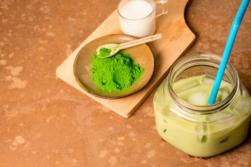 Iced green tea Iced green tea with milk on brown grunge background