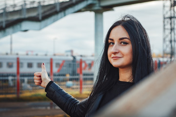 Woman in black dress on the railroad station