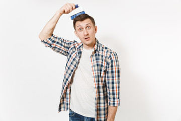 Young fun crazy dizzy wild housekeeper man in checkered shirt comb out tousled brown hair by brush...