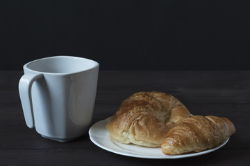 A cup of coffee and breakfast meal