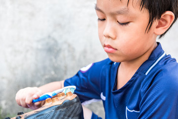 A boy is cleaning his stud after the match. He understand this is his responsibility