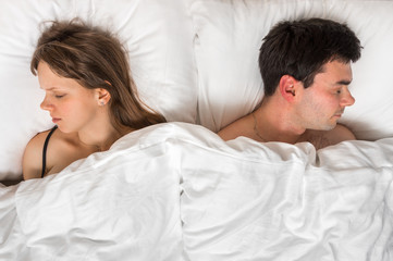 Young couple sleeping together in bed