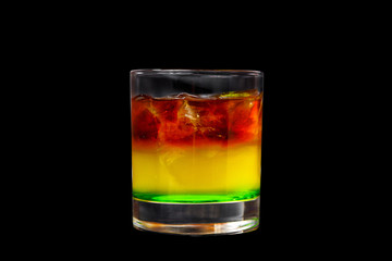 Multicolored, tri-color, cocktail red, yellow, orange, green, gradient. Side view. Isolated black background. Drink in a glass glass for the menu restaurant, bar cafe