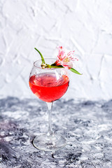 Red cocktail with flowers. Nikerboker.Rom with cranberries