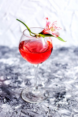 Red cocktail with flowers. Nikerboker.Rom with cranberries