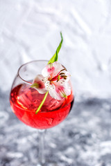Red cocktail with flowers. Nikerboker.Rom with cranberries