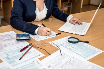 woman work in office - tax return form income calculator