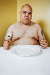 Hungry fat man waiting for dinner