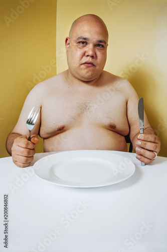 Hungry Fat Man Waiting For Dinner Stock Photo And Royalty Free Hungry Fat Man Waiting For Dinner