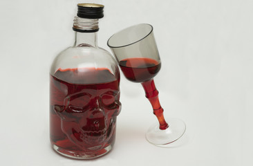 The bottle is a skull with red liquid.