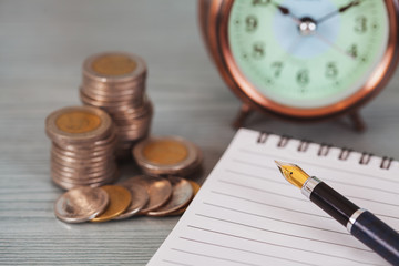 Close up of stacking coins with alarm clock ,Business Finance and Money concept,Save money for the future.