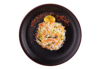 Delicious salad fachoza on a black plate. Salad in a plate isolated on a white background.