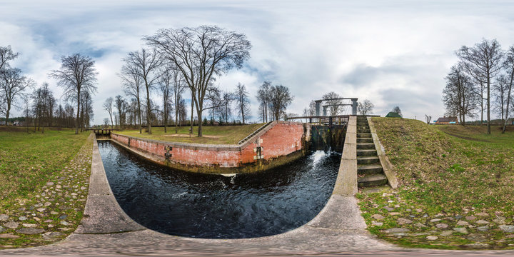 panorama 360 angle view near gateway lock construction on river, canal for passing vessels at different water levels. Full spherical 360 degrees seamless panorama in equirectangular projection