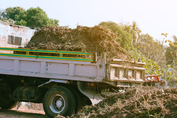 dump truck preparing ground for landscape improvement at property project;Dump truck dumping and...