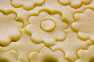close up of  pastry dough cut in flower shape  for biscuits