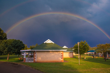 Rainbow over the small summer house in South Africa