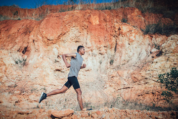 Naklejka premium fit man running outdoor cross-country concept of exercising