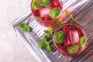 Aperitif with campari, mint and raspberry. Iced lemonade
