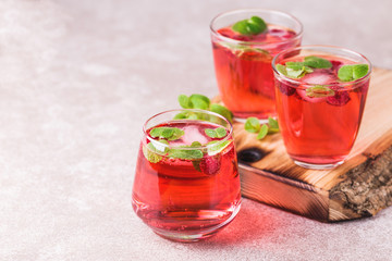 Aperitif with campari, mint and raspberry. Iced lemonade
