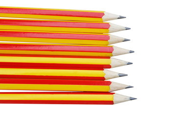 Obraz premium Close up row of pencil red and yellow alternating patterns isolated on white background