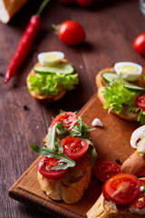 Breakfast sandwich with homemade paste, vegetables and fresh greens, shallow depth of field