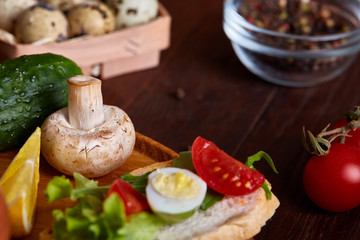 Breakfast sandwich with homemade paste, vegetables and fresh greens, shallow depth of field