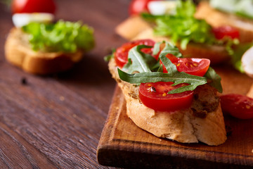 Breakfast sandwich with homemade paste, vegetables and fresh greens, shallow depth of field