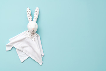 Toy Comforter bunny on a blue background. handy toy for grasping the hands of babies.
