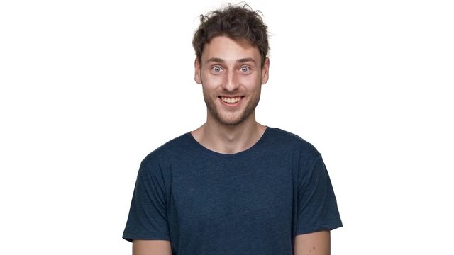 Portrait of brunette handsome guy having bristle nodding and expressing approval, isolated over white background in studio closeup. Concept of emotions