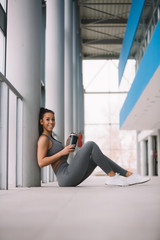 Obraz premium Beautiful girl knows that for the best results she needs to drink a lot of water during training