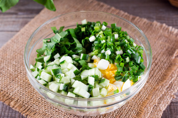Salad with green onions, egg, cucumber in a bowl