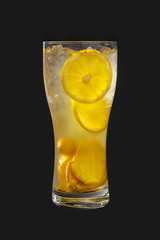 A single-colored, yellow, transparent cocktail in a high glass with crushed ice of frappe and lemon and ginger. Side view. Isolated black background. Drink for the menu restaurant, bar, cafe