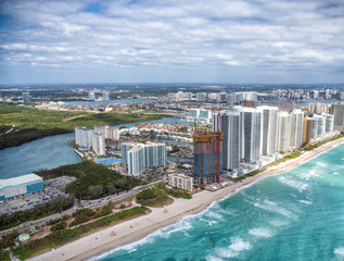 Aerial view of Miami Beach skyscrapers along the sea on a cloudy day