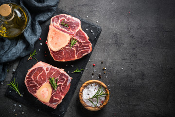 Fototapeta na wymiar Raw beef steak osso bucco on black. Marble meat.