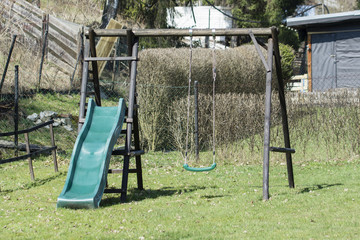 Children's swing and slides on the lawn.
