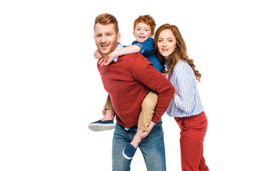 happy parents with cute little son smiling at camera isolated on white