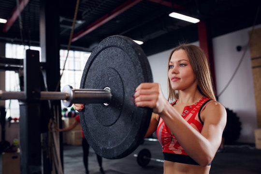 Image of athlete girl in sports clothes with barbell