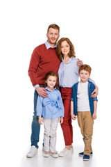 Fototapeta na wymiar happy redhead family with two children standing together and smiling at camera isolated on white